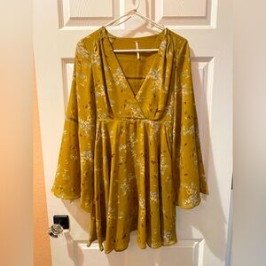 Mustard-yellow Free People dress w/ floral print, bell sleeves, and a flowy fit